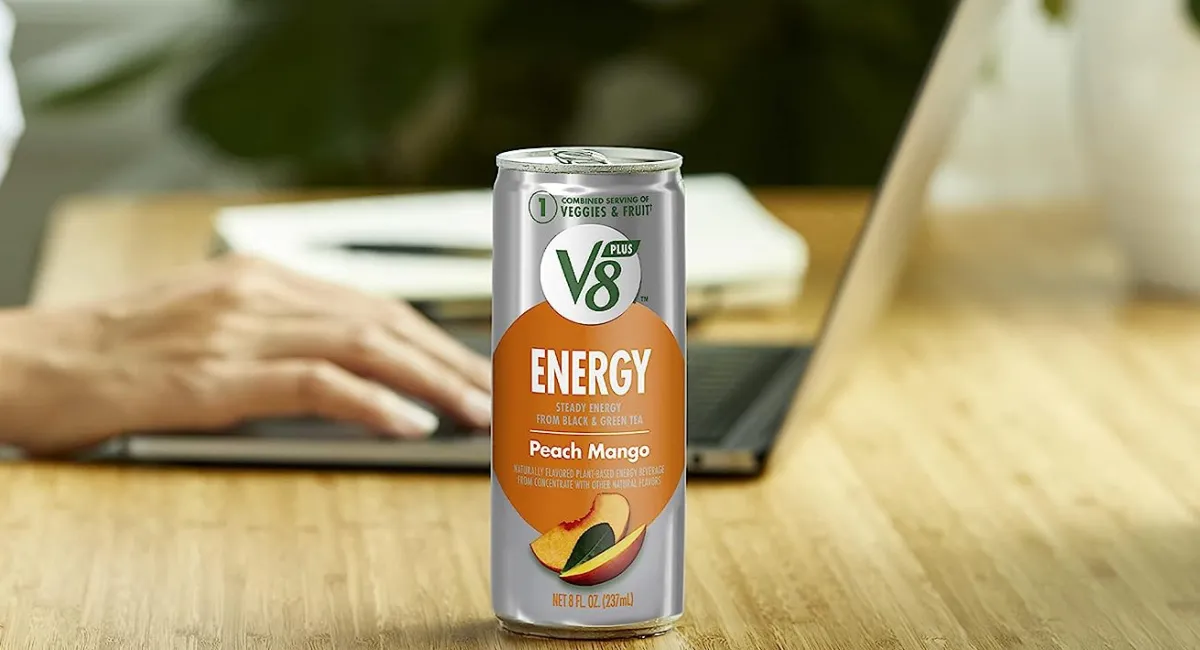 Woman On Laptop Giving A V8 Energy Drink In Peach Mango Flavor