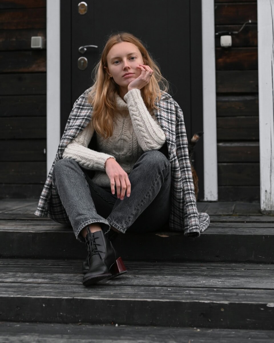 Woman Wearing Sweater And Draped Plaid Blazer
